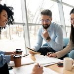 coworkers working and discussing ideas in the workplace